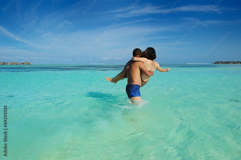 asian couple enjoying summer on beach