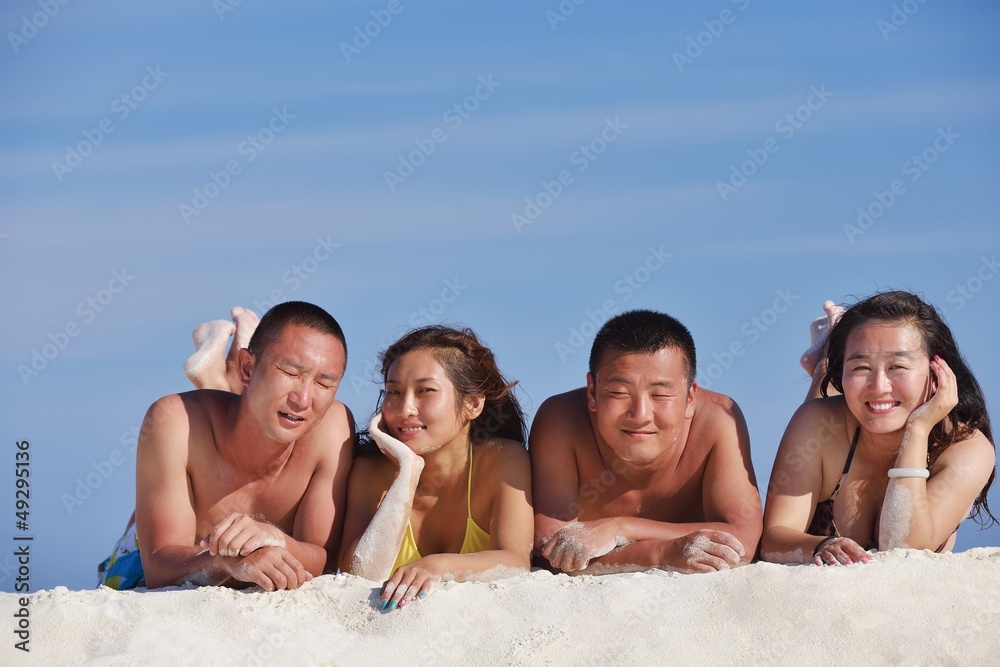 group of happy young people have fun on bach group of happy young people have fun on bach