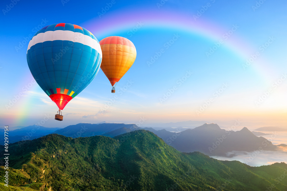 Obraz premium Colorful hot-air balloons flying over the mountain