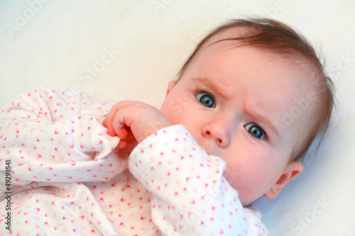 sad baby girl looking at camera close up