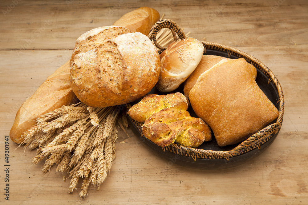 assortment of fresh baked bread on wood table