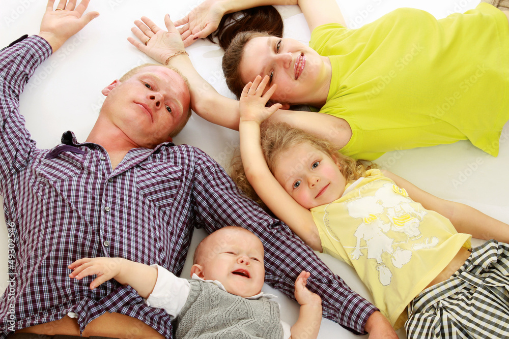 Peaceful family lying in circle on the wall-to