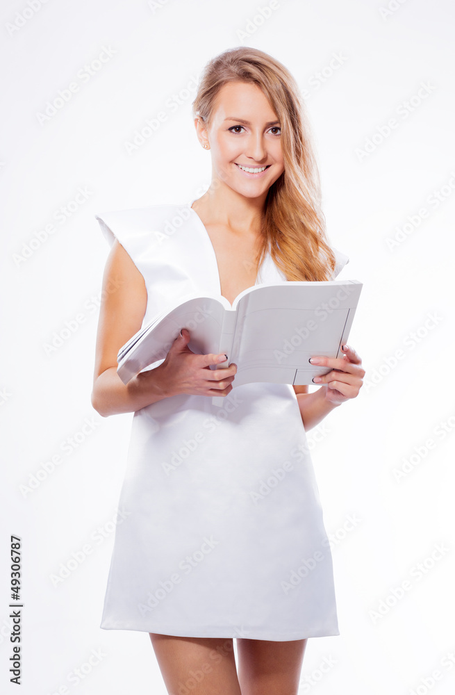 beautiful girl holds in her hand an open white book beautiful girl holds in her hand an open white book