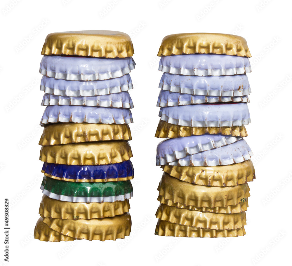 Isolated bottle caps of beer at the many layers. Isolated bottle caps of beer at the many layers.