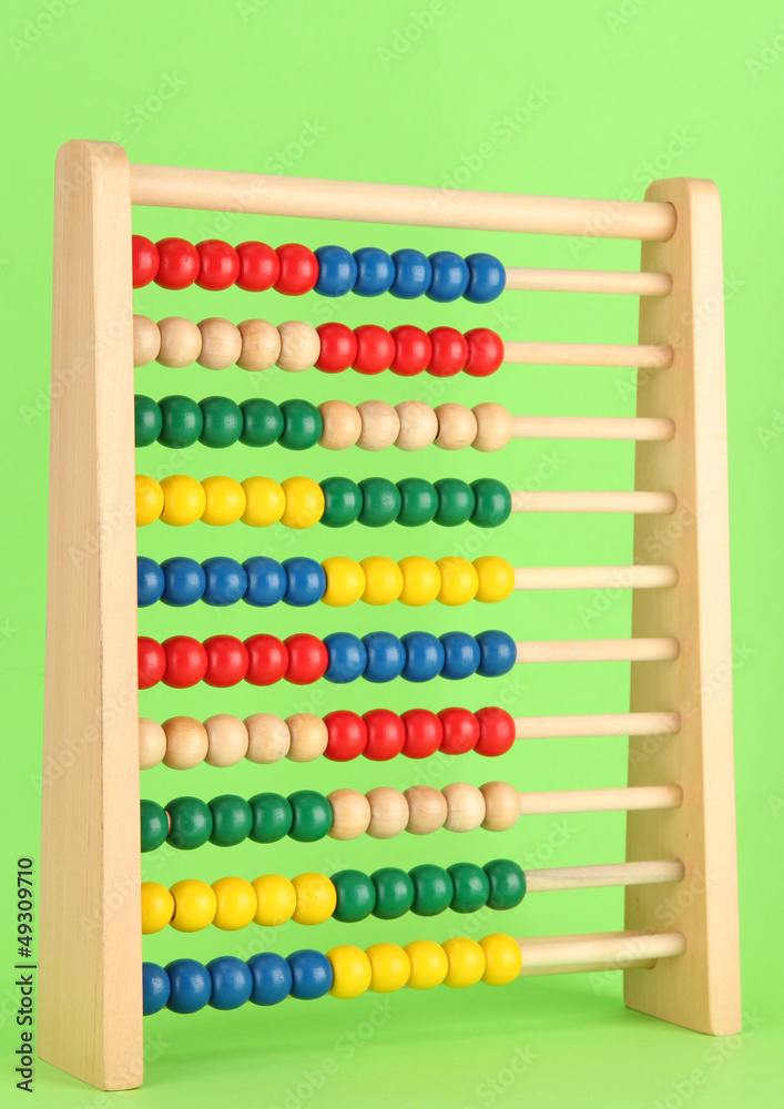 Bright wooden toy abacus, on green background Bright wooden toy abacus, on green background