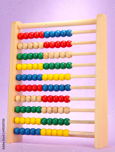 Bright wooden toy abacus  on purple background