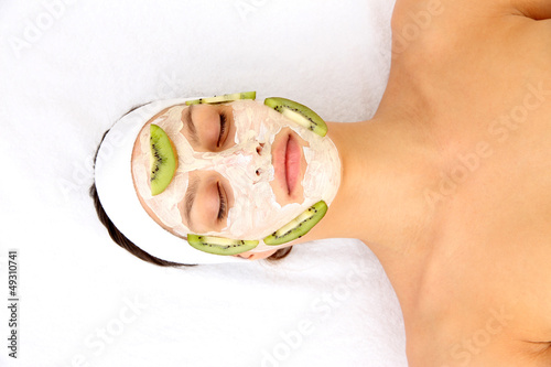 Young woman with clay facial mask