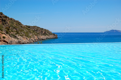 Fototapeta Naklejka Na Ścianę i Meble -  Infinity swimming pool with a view on Aegean Sea at the luxury h
