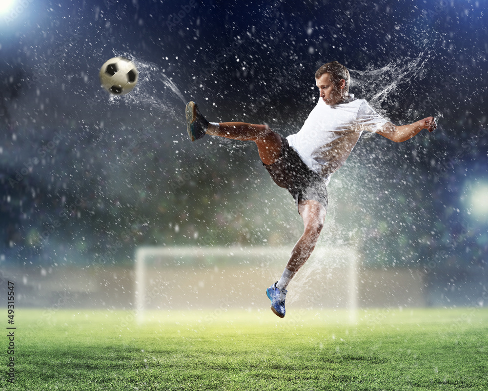 Naklejka premium football player striking the ball