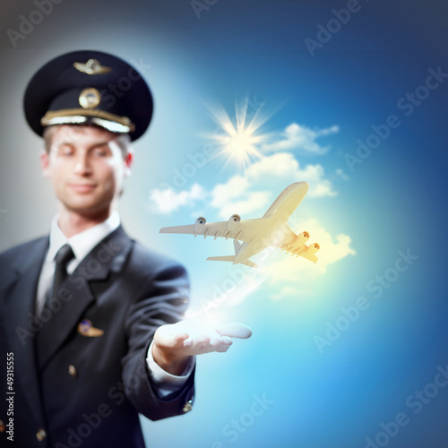 Image of pilot with plane in hand photo