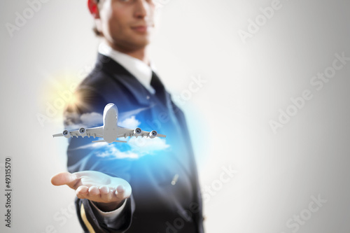 Image of pilot with plane in hand photo