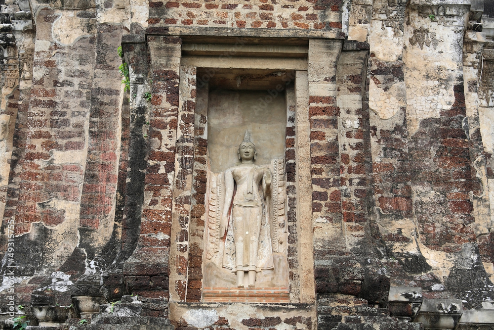 Ancient Buddha statue attached on old brick pagoda