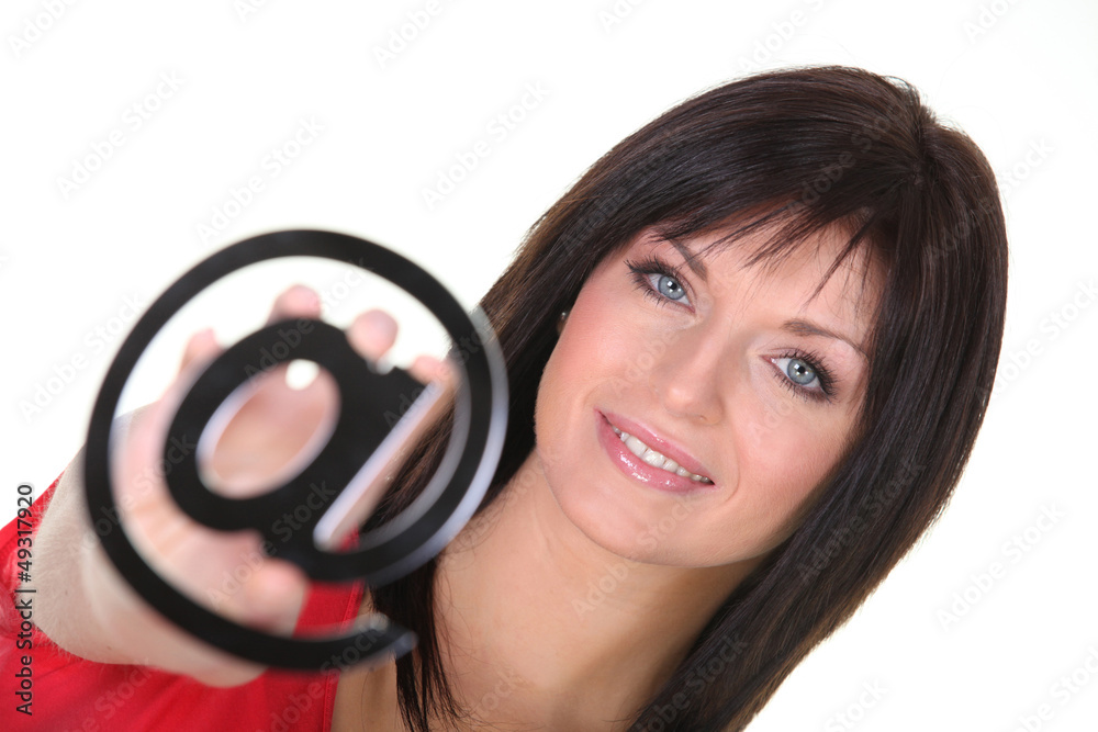 Woman holding an @ sign