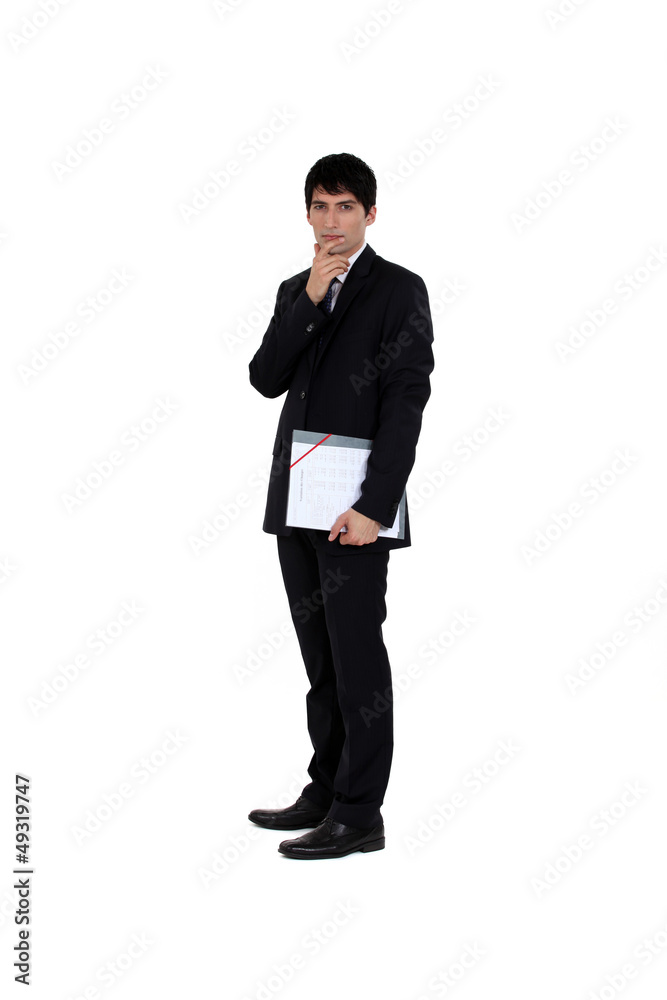 young businessman with finger to his mouth isolated on white young businessman with finger to his mouth isolated on white