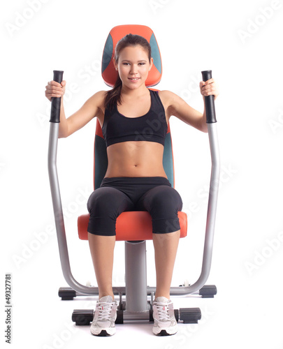 Brunette woman on orange  hydraulic exerciser photo