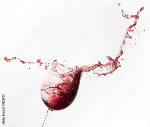 red wine splashing out of a glass, isolated on white