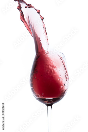 red wine splashing out of a glass, isolated on white