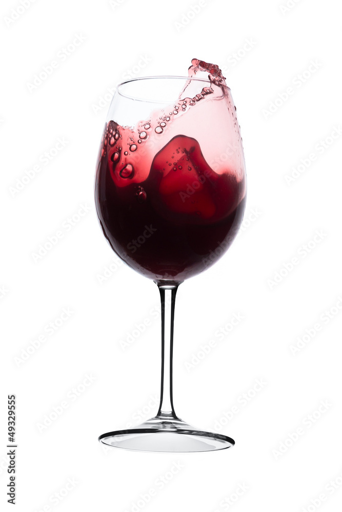 red wine splashing out of a glass, isolated on white
