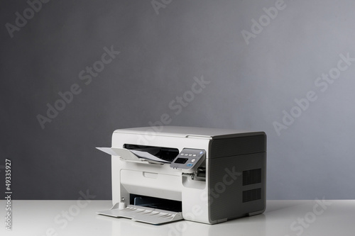 Laser printer isolated on grey background.