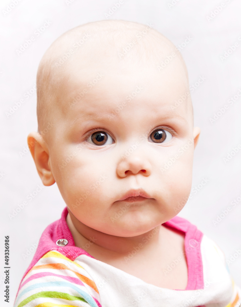 Little calm brown eyed baby closeup studio portrait Little calm brown eyed baby closeup studio portrait