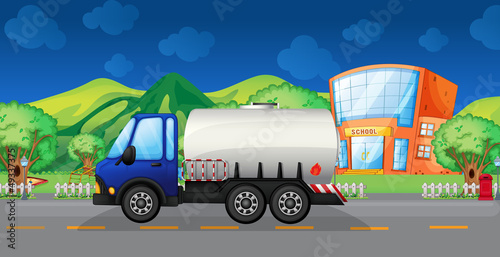 An oil truck passing a school