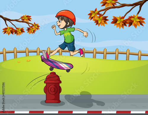 A fire hydrant and a boy playing skate board
