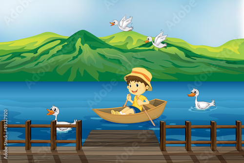A boy riding on a wooden boat