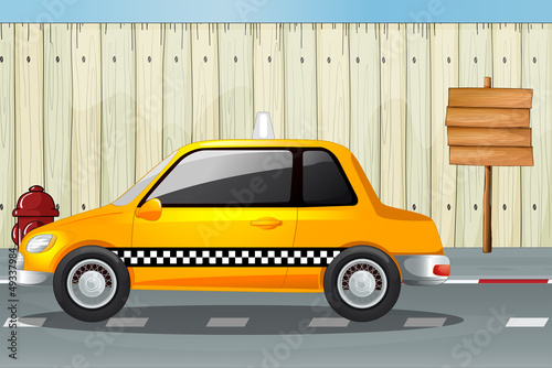 A car, a fire hydrant and a notice board