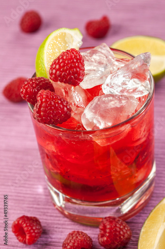Red drink with raspberries and ice