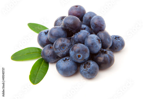 Blueberries with green leaves isolated on white background