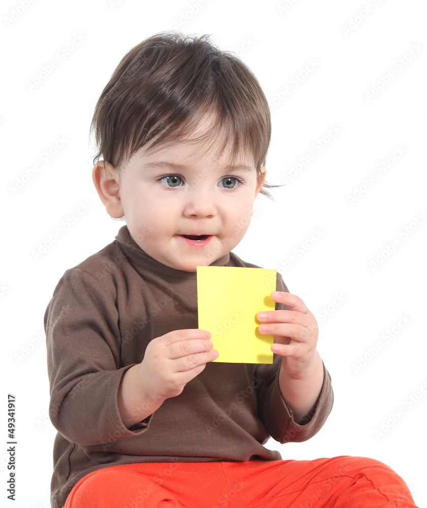 Baby holding and showing a blank yellow note Baby holding and showing a blank yellow note