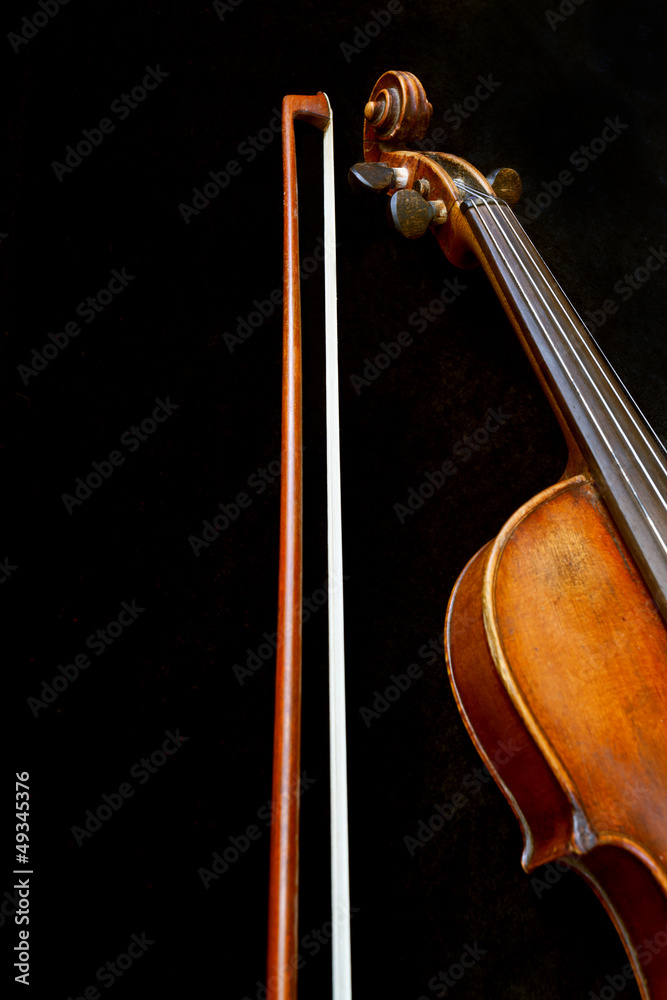 violin neck and bow on black