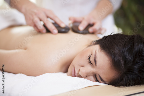 Pretty woman getting a hot stone massage at home