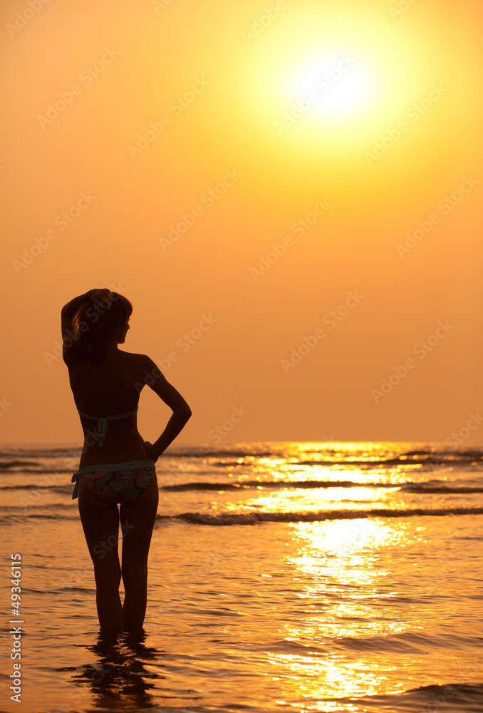 Silhouette of the girl and orange sunset