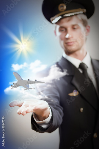 Image of pilot with plane in hand photo