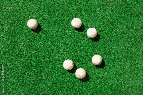 Golfs ball on green grass