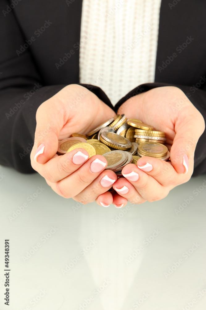 Woman hands with coins isolated on white.