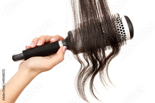 Dark curls brushing comb isolated on white