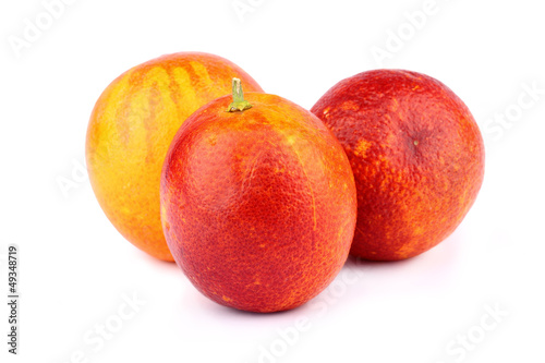 Three Sicilian red oranges on white