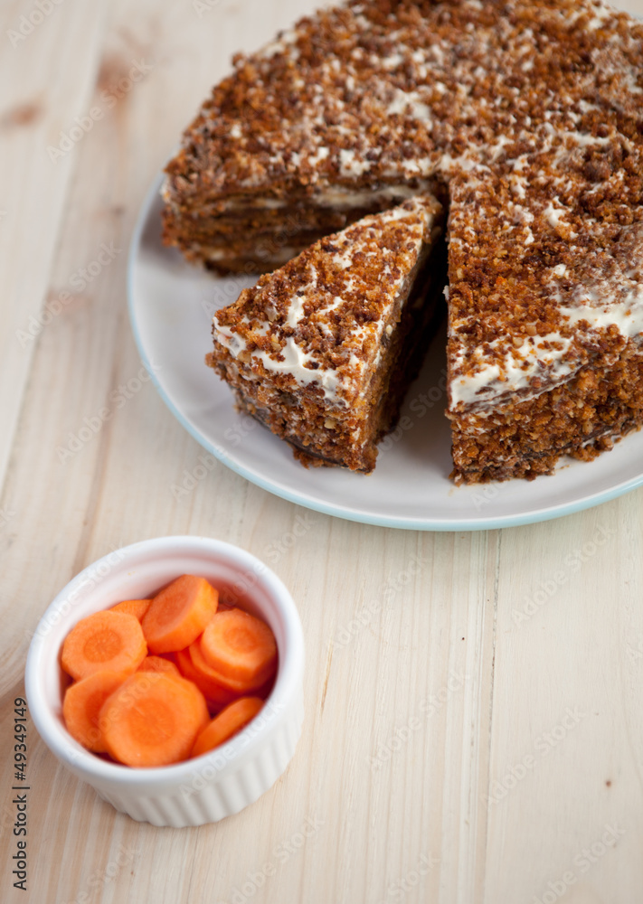 Homemade carrot and walnut cake on a wooden table