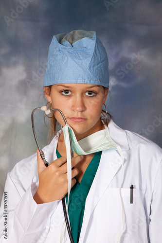 Obraz na plátně Healthcare worker in white lab coat and surgical cap
