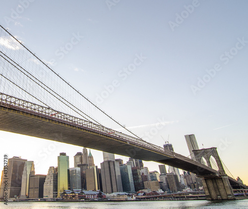 Fototapeta Naklejka Na Ścianę i Meble -  Upward view of Brooklyn Bridge at Sunset with Manhattan Skyline