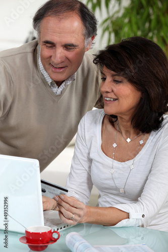 Middle-aged couple doing some on-line shopping