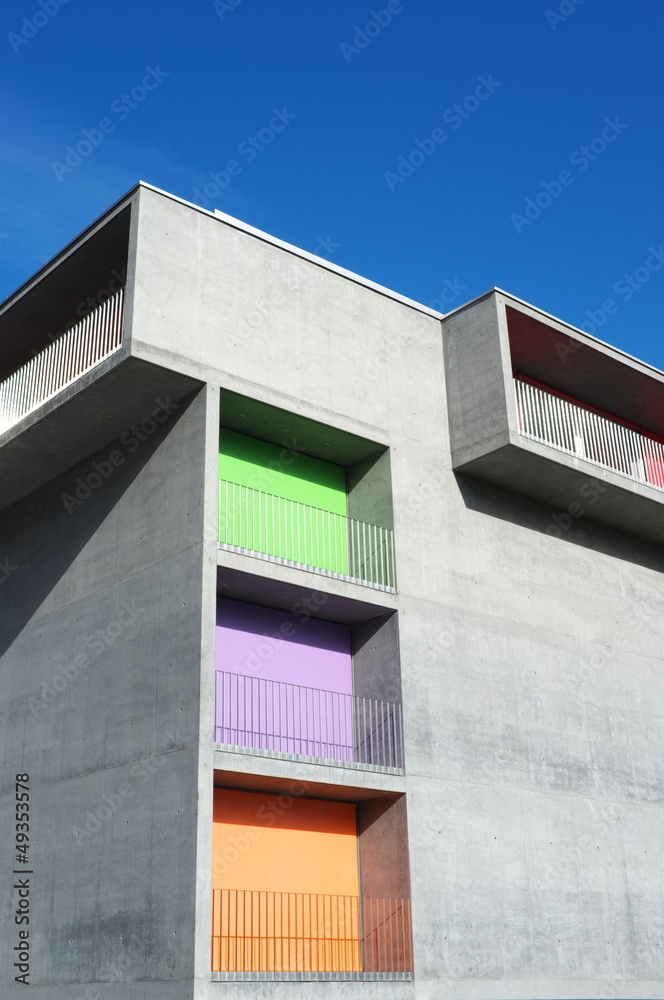 Modern concrete building with colored curtains