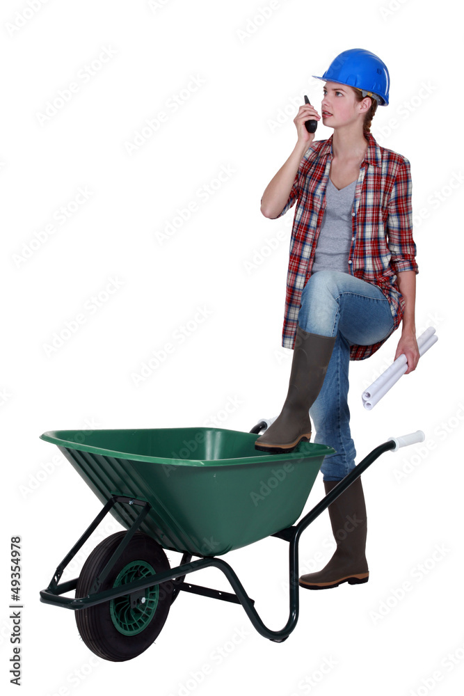 Female foreman with wheelbarrow and radio Female foreman with wheelbarrow and radio