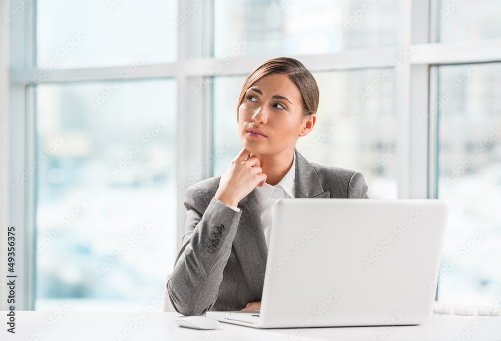 Portrait of business woman resting chin on hand in front of her Portrait of business woman resting chin on hand in front of her