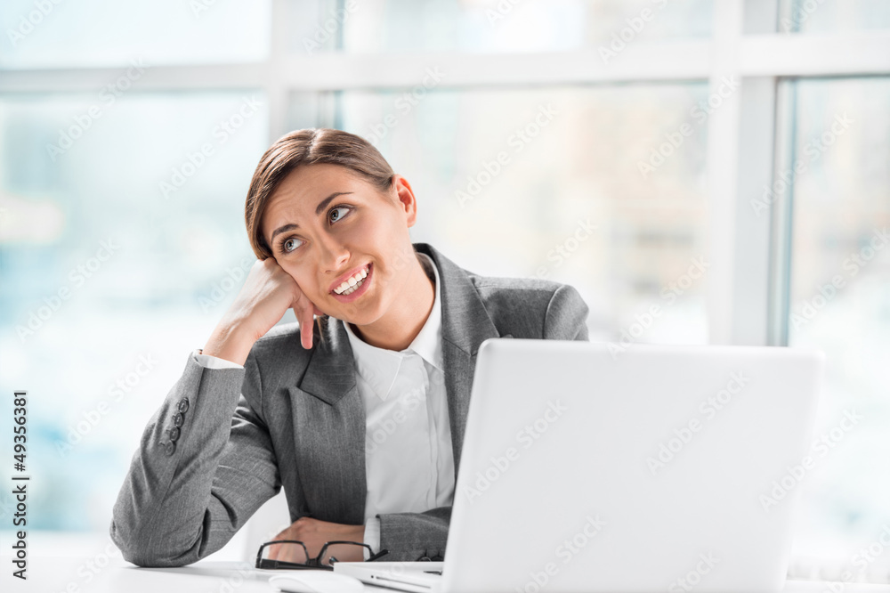 Portrait of thoughtful business woman working on computer at off Portrait of thoughtful business woman working on computer at off