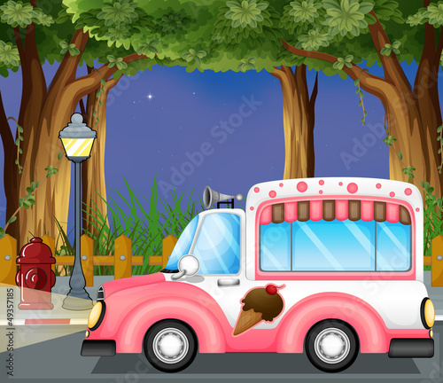 A pink ice cream car in the street