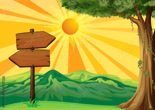 A wooden signboard with a view of the sunset