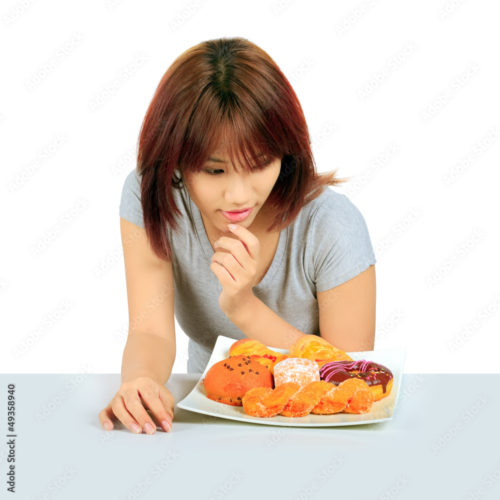 Isolated young asian woman with a donuts on the table Isolated young asian woman with a donuts on the table